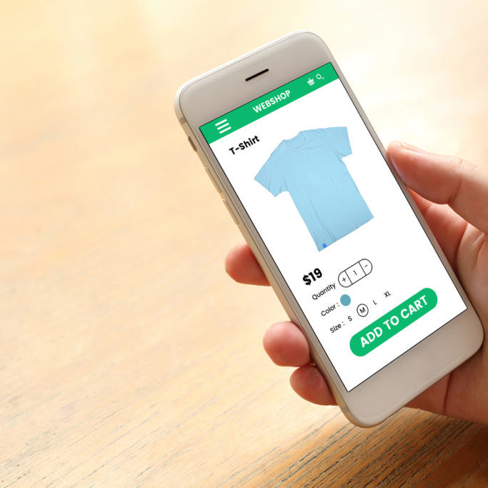 Hand holding smartphone with ecommerce screen website